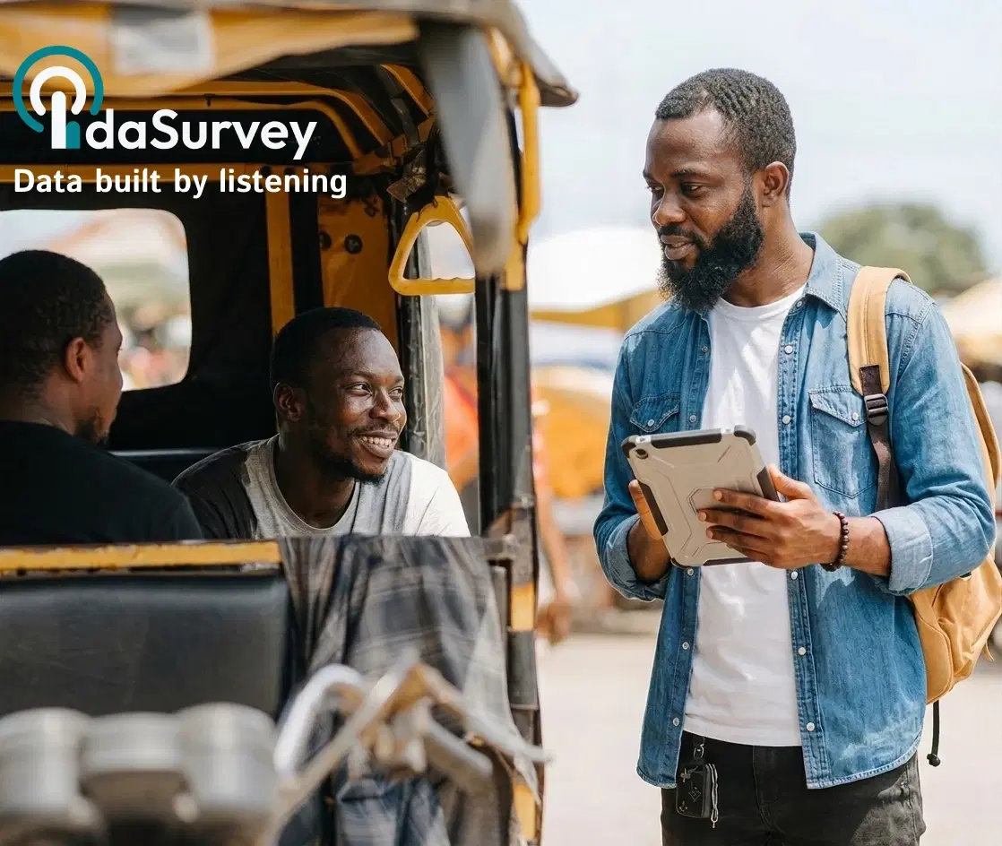 A field data enumerator using a tablet while speaking with transport workers